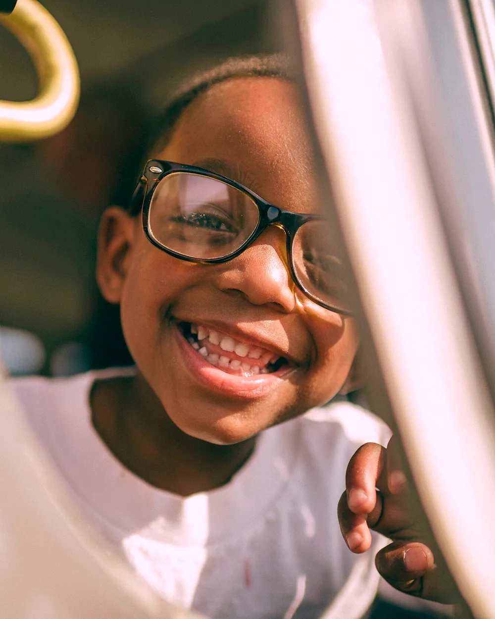 Child in glasses grinning